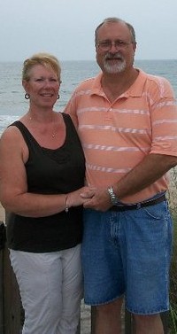 Gail & Harlan Banks standing by the ocean.